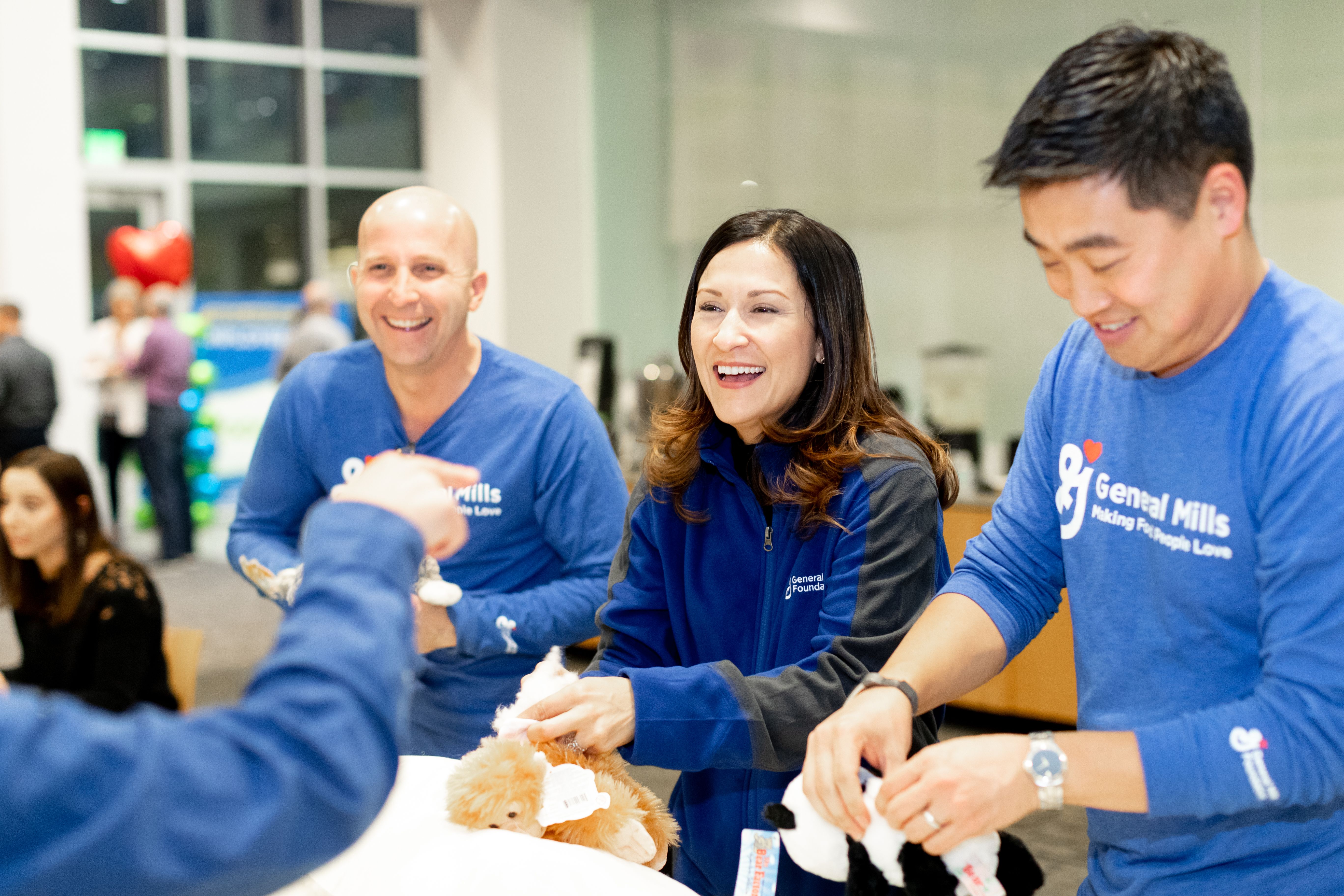 Employees volunteering and smiling